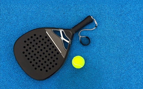 Padel racket with solid face and perforated design used in padel sport